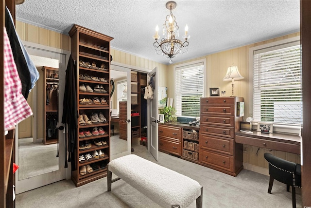 spacious closet featuring light carpet and a notable chandelier