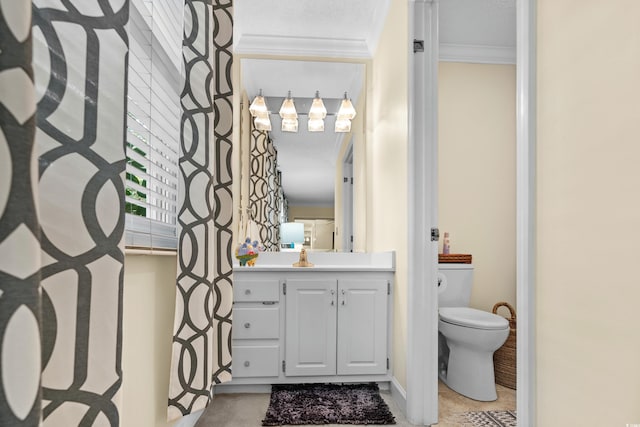 bathroom featuring crown molding, vanity, and toilet