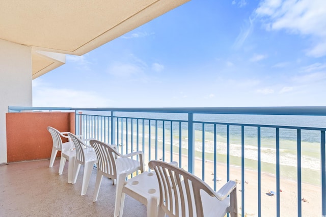 balcony featuring a water view and a view of the beach