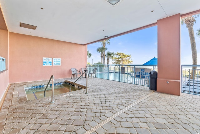 view of swimming pool with a patio