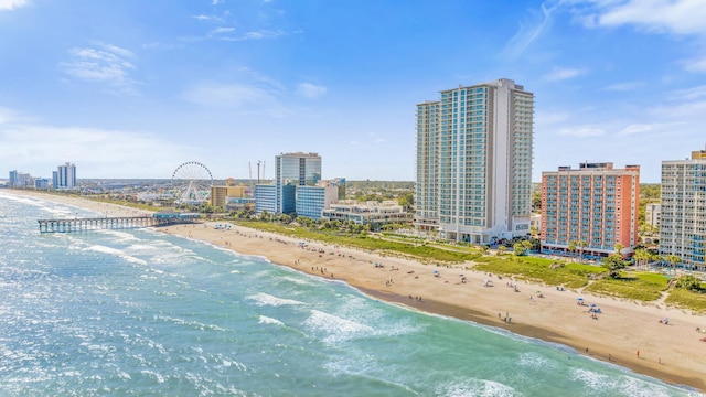 birds eye view of property with a water view and a view of the beach