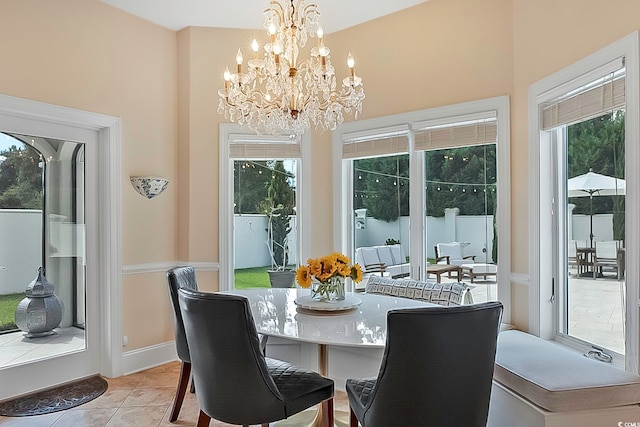 dining area featuring an inviting chandelier and light tile patterned flooring