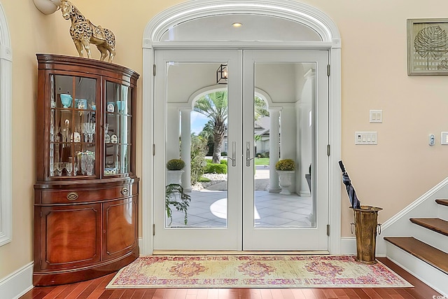 doorway with hardwood / wood-style floors and french doors