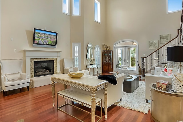 living room featuring hardwood / wood-style floors and a high ceiling