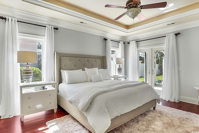 bedroom featuring multiple windows, wood-type flooring, and ceiling fan