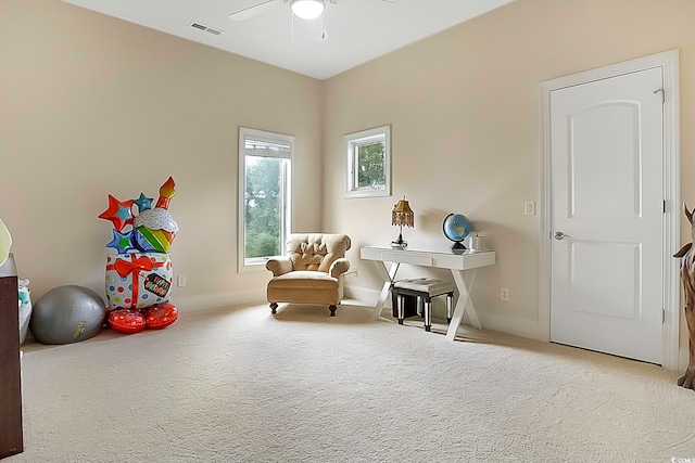 sitting room featuring carpet and ceiling fan