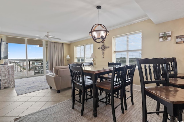 tiled dining area featuring ceiling fan and ornamental molding