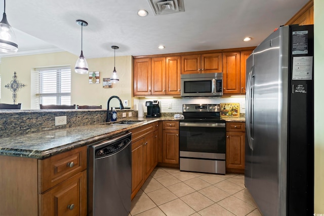 kitchen with crown molding, sink, stainless steel appliances, hanging light fixtures, and light tile patterned floors