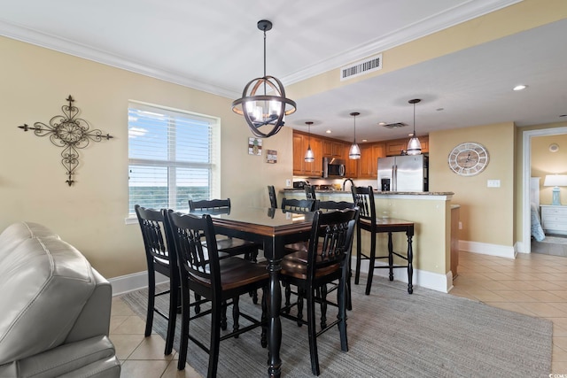 tiled dining room with an inviting chandelier and crown molding