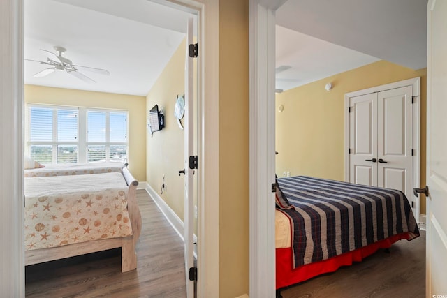 bedroom with ceiling fan, a closet, and wood-type flooring