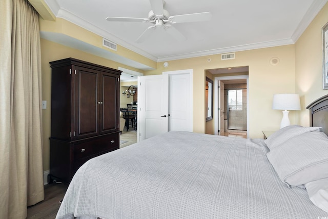 bedroom featuring dark wood-type flooring, crown molding, ensuite bath, and ceiling fan