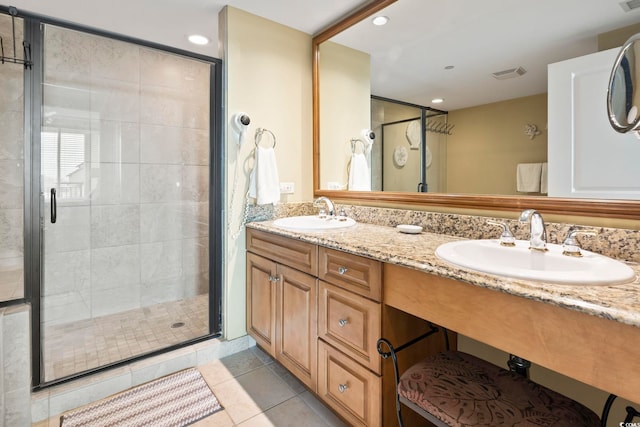 bathroom with tile patterned flooring, vanity, and a shower with shower door