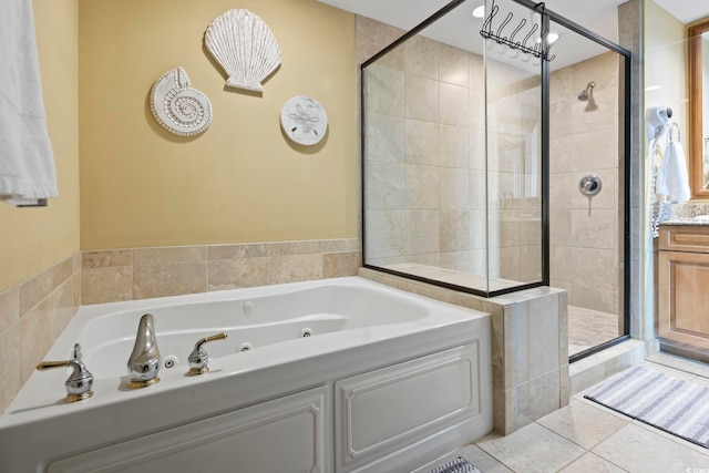 bathroom featuring tile patterned flooring, shower with separate bathtub, and vanity