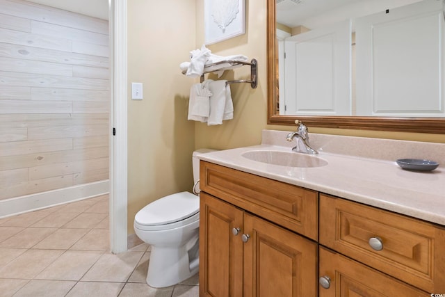 bathroom with tile patterned flooring, vanity, and toilet