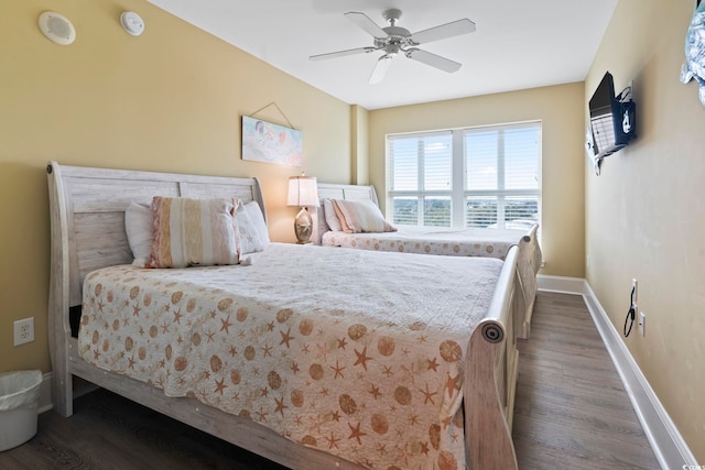 bedroom with ceiling fan and dark hardwood / wood-style floors