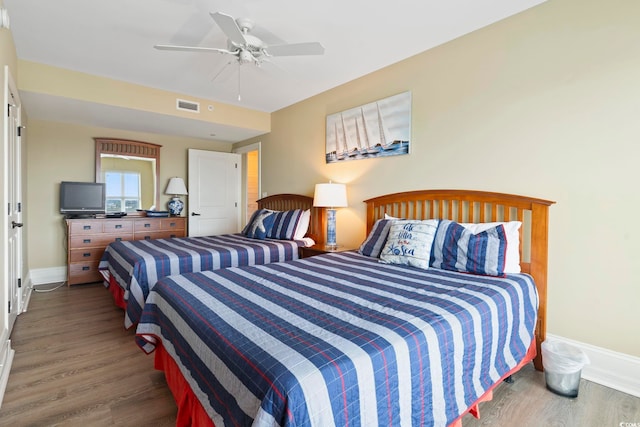 bedroom featuring dark hardwood / wood-style floors and ceiling fan