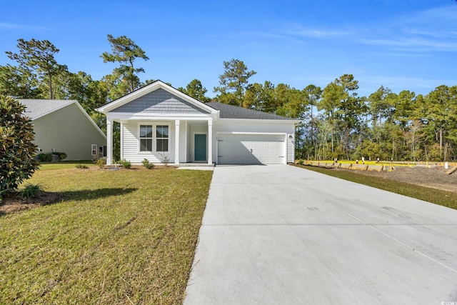 view of front of house with a front lawn, driveway, and an attached garage