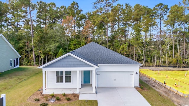 ranch-style house featuring driveway, a garage, roof with shingles, and a front lawn