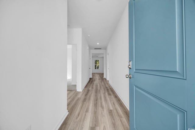 corridor featuring light hardwood / wood-style floors