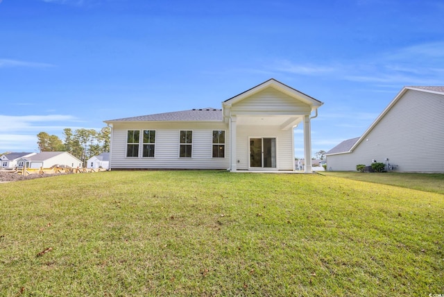 back of house featuring a yard