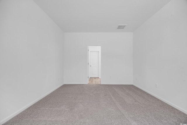 unfurnished room with baseboards, visible vents, and carpet floors
