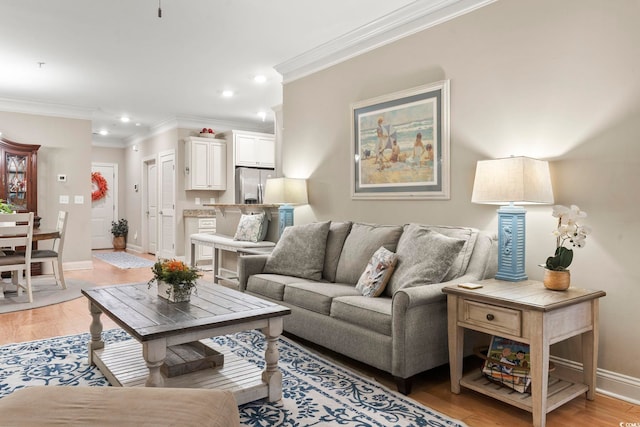 living room featuring crown molding and light hardwood / wood-style flooring