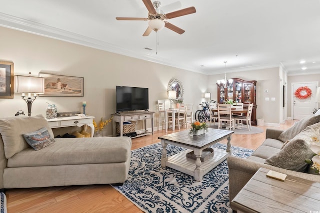 living room with crown molding, ceiling fan with notable chandelier, and light wood-type flooring