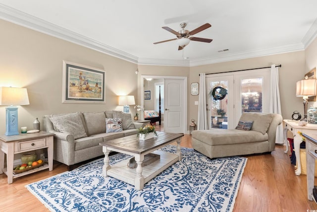 living room with ornamental molding, hardwood / wood-style floors, and ceiling fan