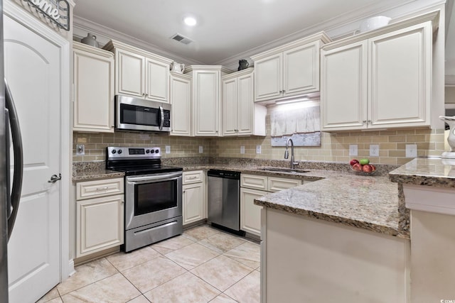 kitchen featuring sink, light stone counters, light tile patterned floors, stainless steel appliances, and backsplash