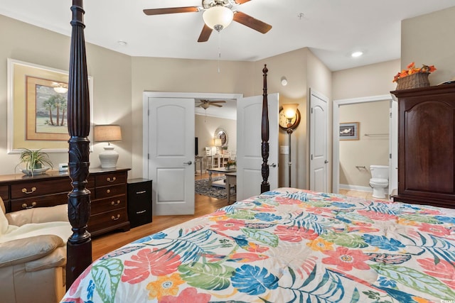 bedroom featuring ceiling fan, ensuite bathroom, and light wood-type flooring