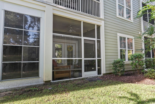 exterior space with a yard and ceiling fan