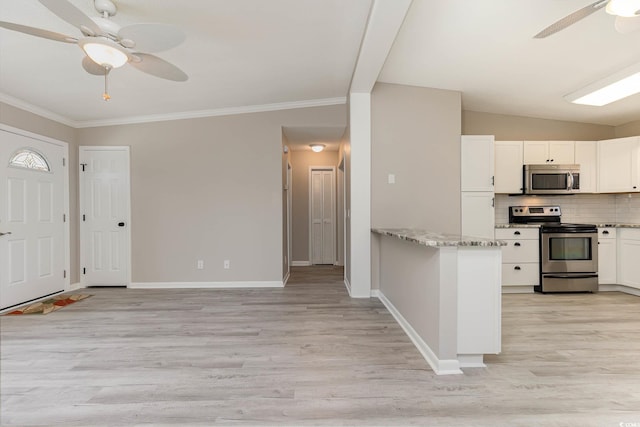 kitchen featuring light stone countertops, backsplash, light hardwood / wood-style floors, stainless steel appliances, and white cabinets