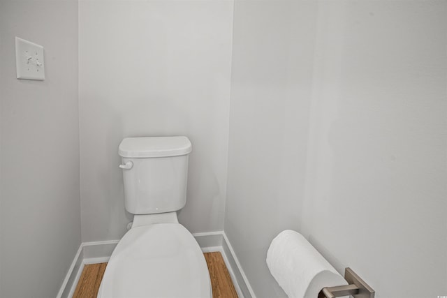 bathroom with hardwood / wood-style floors and toilet