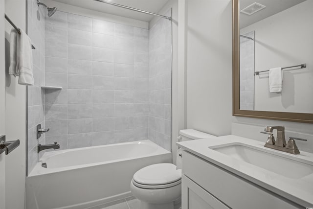 full bathroom featuring tile patterned flooring, vanity, toilet, and tiled shower / bath