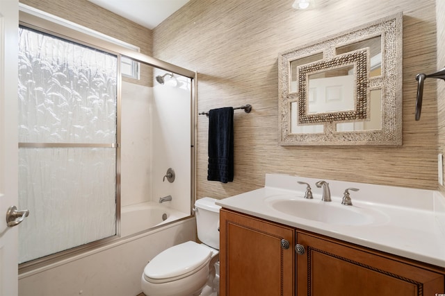 full bathroom with vanity, shower / bath combination with glass door, and toilet