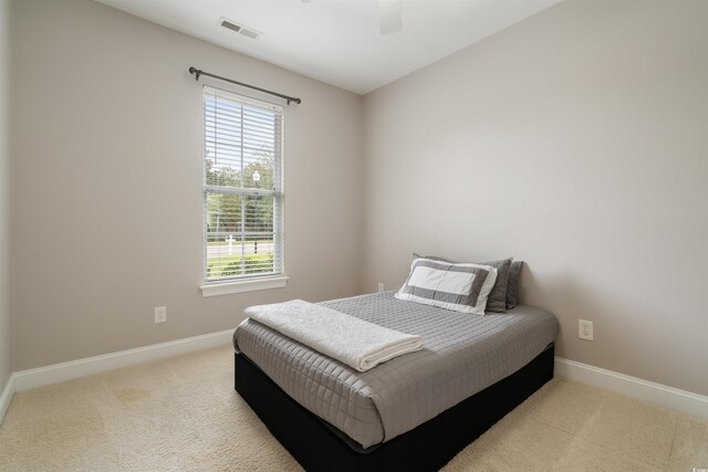 bedroom featuring light carpet and ceiling fan