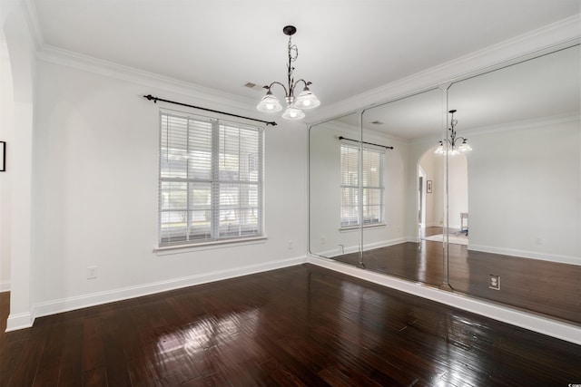 unfurnished room with wood-type flooring, a chandelier, and crown molding