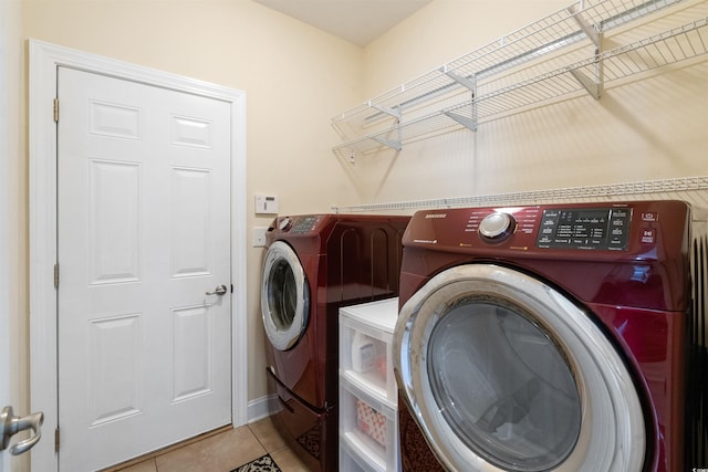 washroom with washing machine and dryer and light tile patterned floors