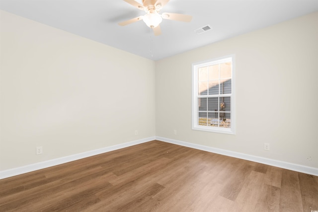 spare room with hardwood / wood-style flooring and ceiling fan