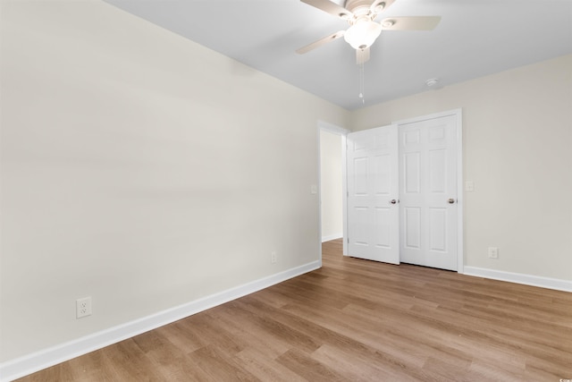 unfurnished bedroom featuring a closet, light wood-type flooring, and ceiling fan