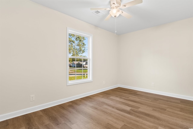 spare room with wood-type flooring and ceiling fan