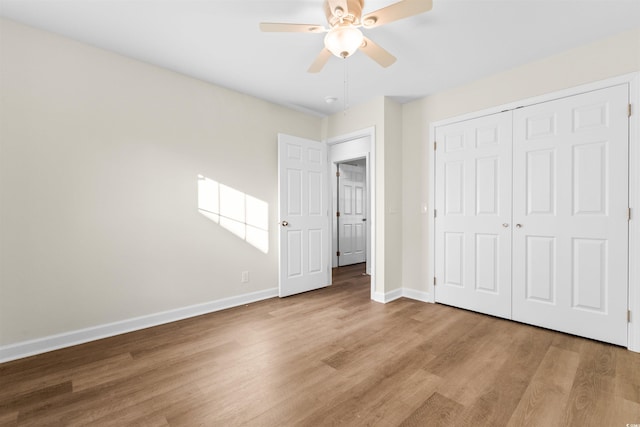 unfurnished bedroom featuring light hardwood / wood-style flooring, a closet, and ceiling fan