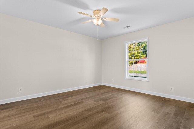 unfurnished room featuring ceiling fan and dark hardwood / wood-style floors