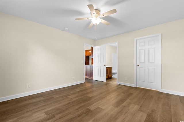 unfurnished bedroom featuring ceiling fan and dark hardwood / wood-style flooring