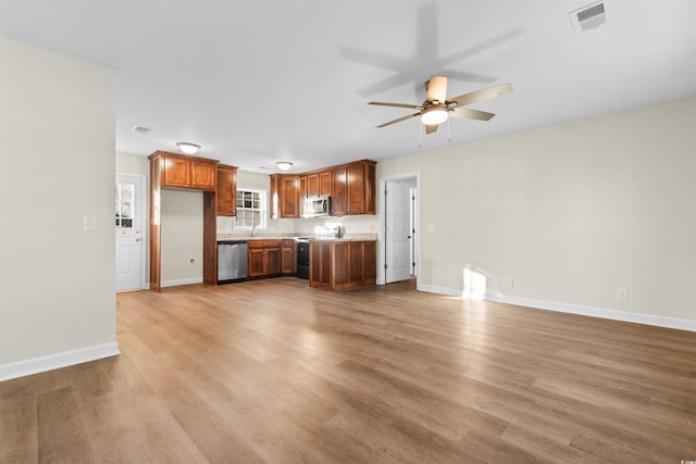 kitchen featuring light hardwood / wood-style floors, stainless steel appliances, and ceiling fan