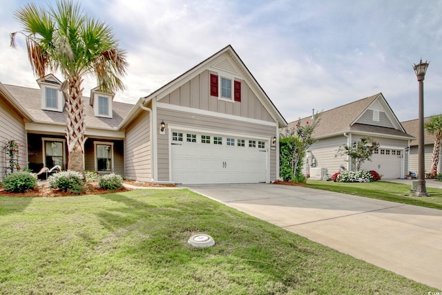 view of front of property with a garage, a front yard, and ac unit