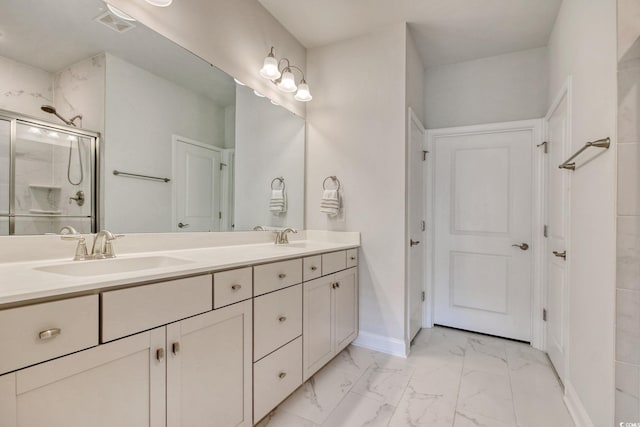 bathroom with vanity and a shower with door