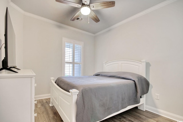 bedroom featuring ceiling fan, ornamental molding, and dark hardwood / wood-style floors