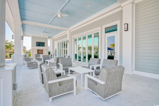 view of patio / terrace with an outdoor living space with a fireplace