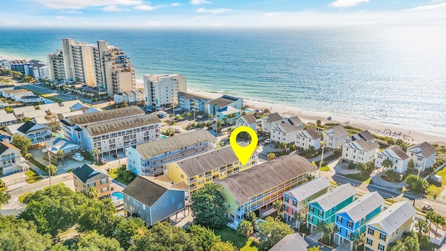 drone / aerial view featuring a water view and a beach view